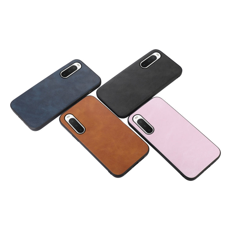 Cowhide-textured PU phone cases in blue, brown, black, and pink, back camera cutouts