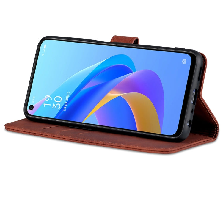 Brown leather flip phone case worn as a stand with open viewing cover
