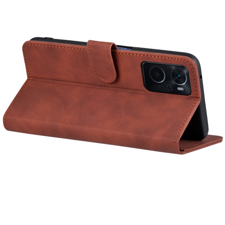 Brown flip leather phone case with magnetic-style strap and camera opening