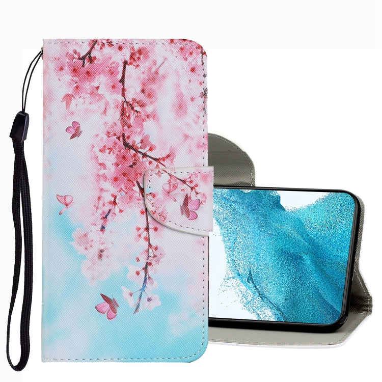 Leather folio phone case with pink cherry blossom branch pattern, wrist strap