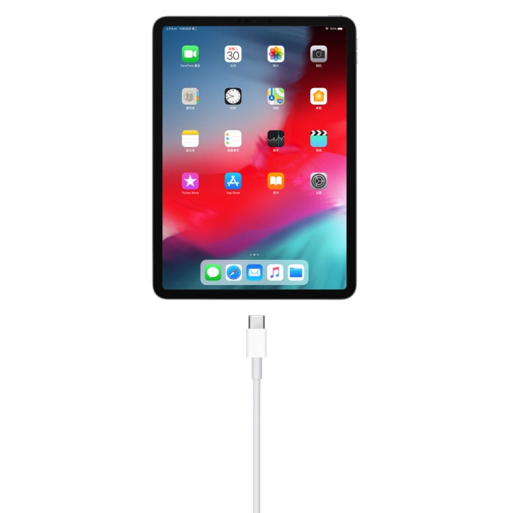 USB-A to USB-C data cable with white connector inserted into a tablet port