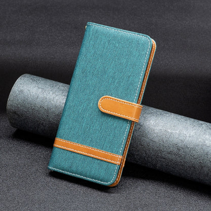 Teal denim-texture leather flip phone case with tan closure strap and stitching