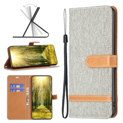 Light gray fabric-texture leather flip phone case with tan tab and wrist strap