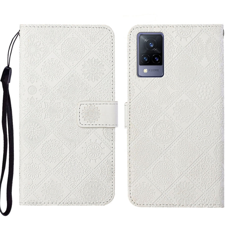 White embossed leather folio phone case with wrist strap and card pocket.
