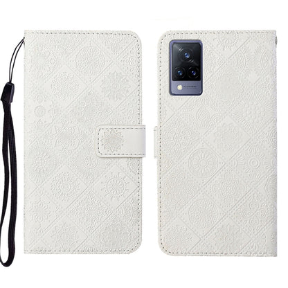 White embossed leather folio phone case with wrist strap and card pocket.