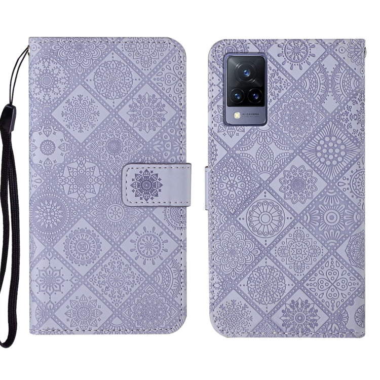 Purple embossed leather folio phone case with wrist strap, card pocket and camera cutout.