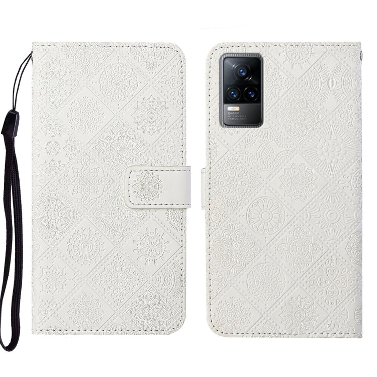 White embossed leather folio phone case with wrist strap, card pocket, and camera cutout.
