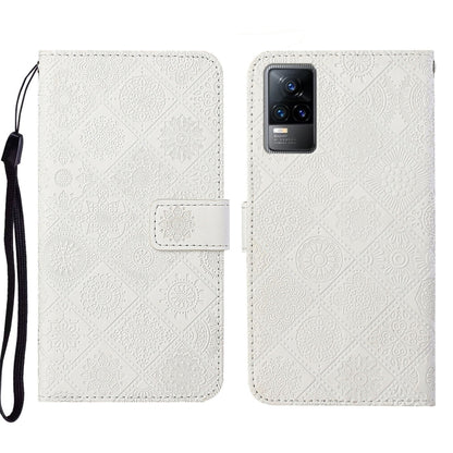 White embossed leather folio phone case with wrist strap, card pocket, and camera cutout.