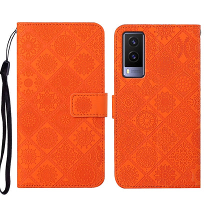 Orange embossed pattern leather-style folio phone case with wrist strap; card slot and rear camera window