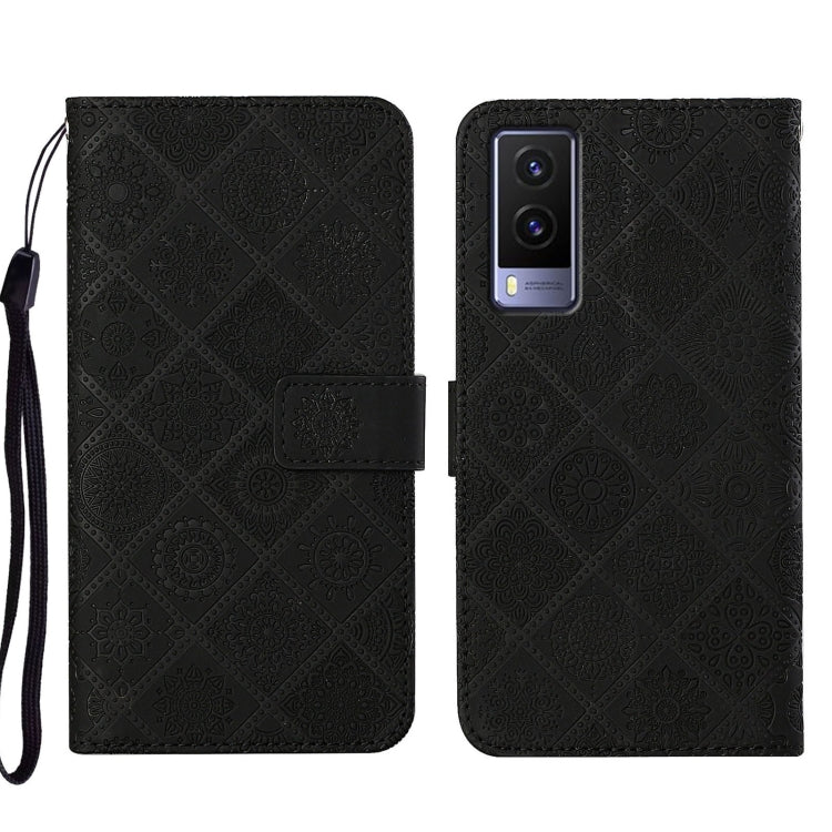 Black embossed pattern leather-style folio phone case with wrist strap; front flap and rear camera cutout