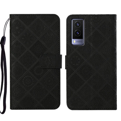 Black embossed pattern leather-style folio phone case with wrist strap; front flap and rear camera cutout