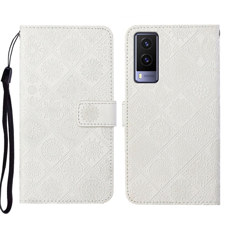 White embossed leather folio phone case with wrist strap and card pocket, visible rear cameras.