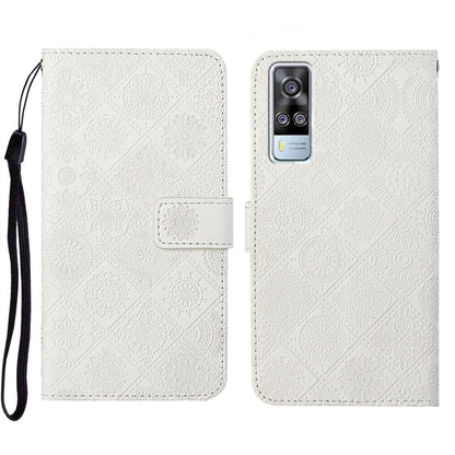 White embossed leather folio phone case with wrist strap and card pocket, phone-camera opening.