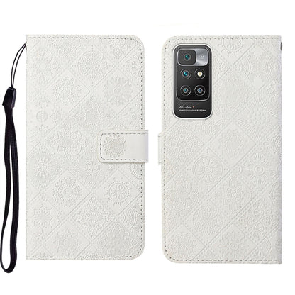 White embossed leather phone case wallet with flip cover and wrist strap.