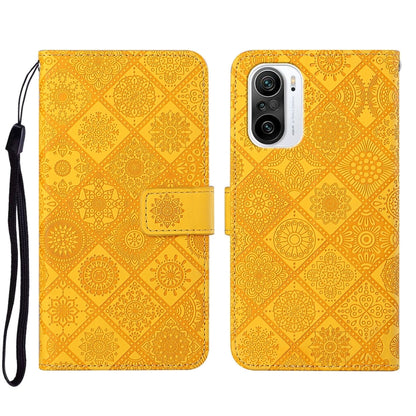 Yellow embossed leather phone case with floral pattern, front flap and camera cutout