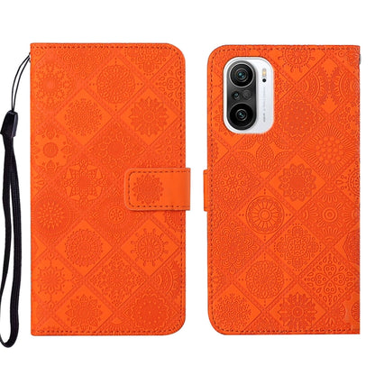 Folio leather phone case with embossed geometric pattern, orange, wrist strap