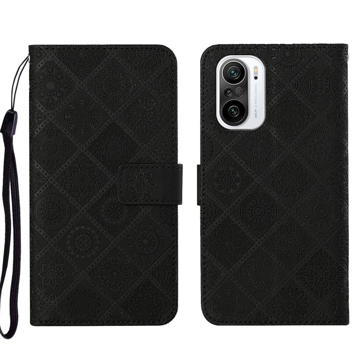 Black embossed leather phone case with folio flap, card slot, and raised camera