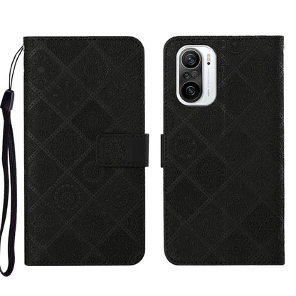 Black embossed leather phone case with folio flap, card slot, and raised camera