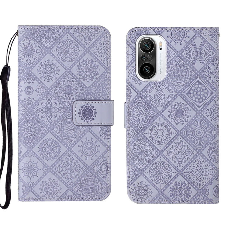Purple embossed leather folio phone case with wrist strap and camera cutout on back