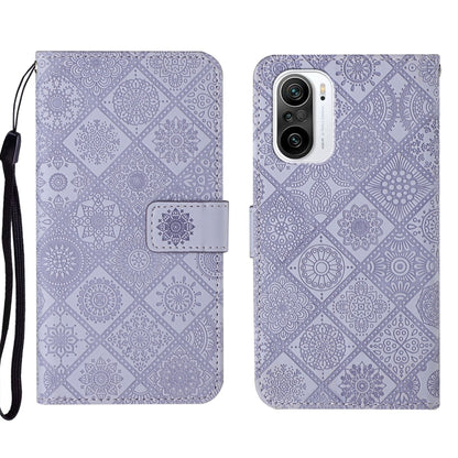 Purple embossed leather folio phone case with wrist strap and camera cutout on back