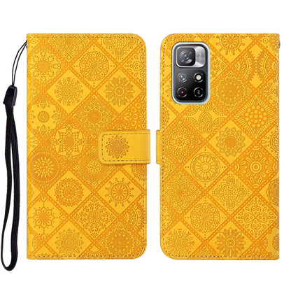 Yellow embossed leather wallet phone case with floral pattern and side strap