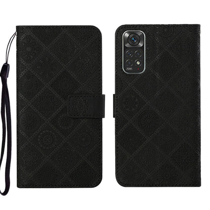 Black embossed leather phone case wallet with flip cover and wrist strap.
