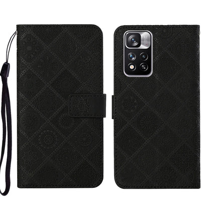 Black embossed leather phone case wallet with flip cover and wrist strap, rear camera view.