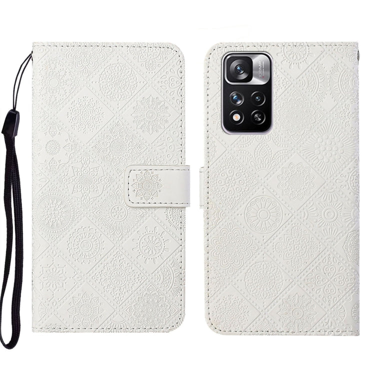 White embossed leather folio phone case with wrist strap, flap closure, camera cutout