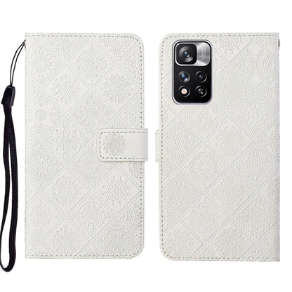 White embossed leather folio phone case with wrist strap, flap closure, camera cutout