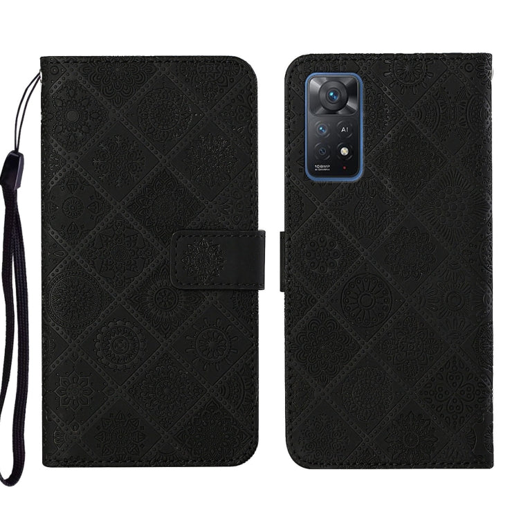 Black embossed leather phone case wallet with flip cover and wrist strap.