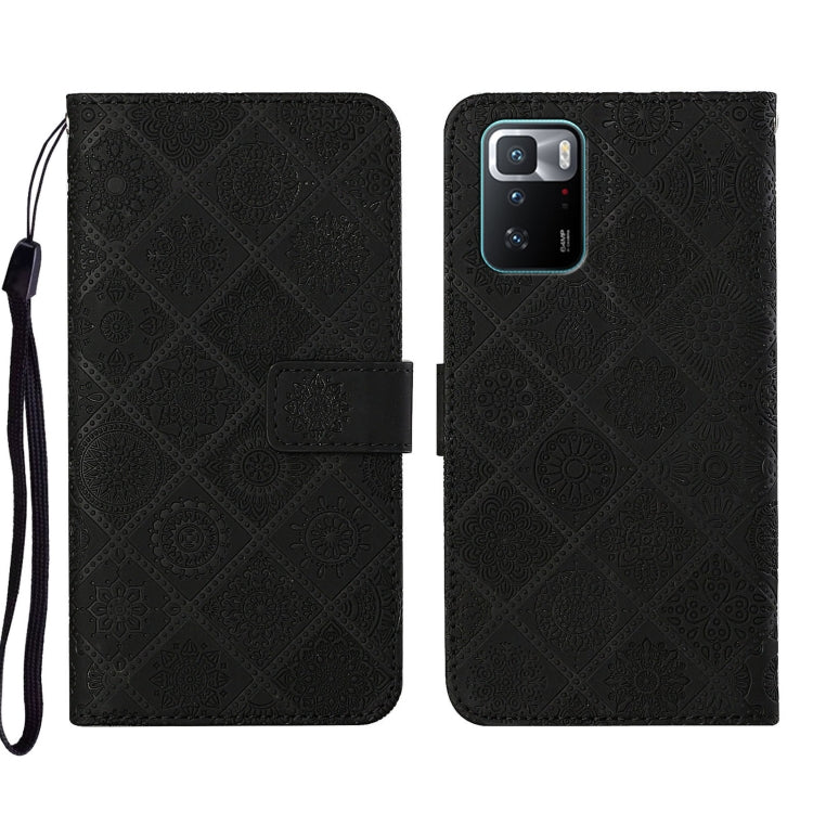 Black embossed leather phone case wallet with flip cover and wrist strap, camera cutout visible.