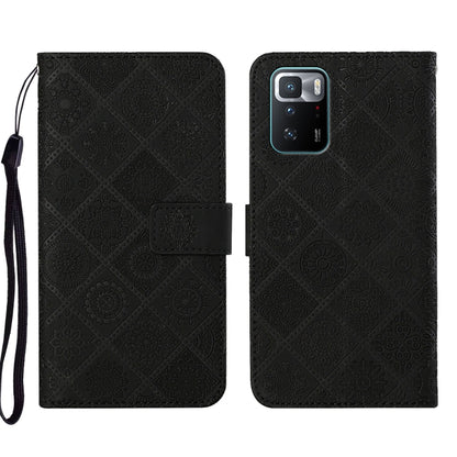 Black embossed leather phone case wallet with flip cover and wrist strap, camera cutout visible.