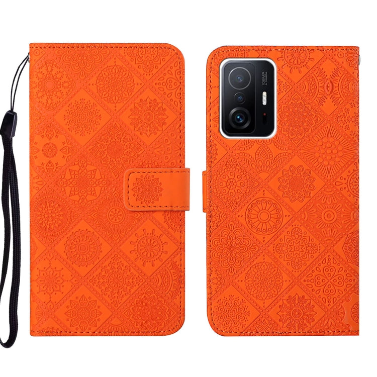 Orange embossed leather phone case with folio flap and dual-tone camera window, wrist strap