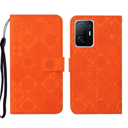 Orange embossed leather phone case with folio flap and dual-tone camera window, wrist strap
