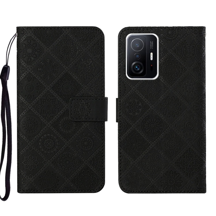 Black embossed leather phone case wallet with flip cover and wrist strap, camera lenses shown.