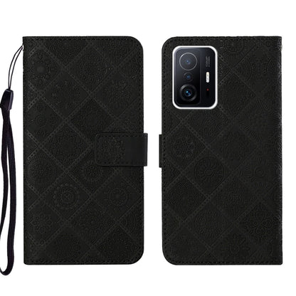 Black embossed leather phone case wallet with flip cover and wrist strap, camera lenses shown.