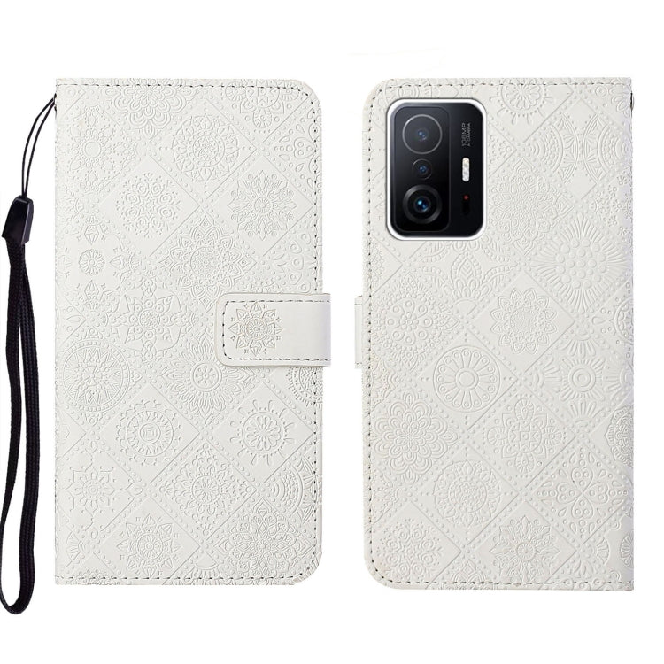 White embossed leather folio phone case with wrist strap, flap closure, rear camera opening