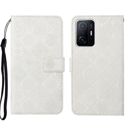 White embossed leather folio phone case with wrist strap, flap closure, rear camera opening