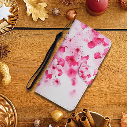 Pink floral flip leather phone case with wrist strap on wood surface