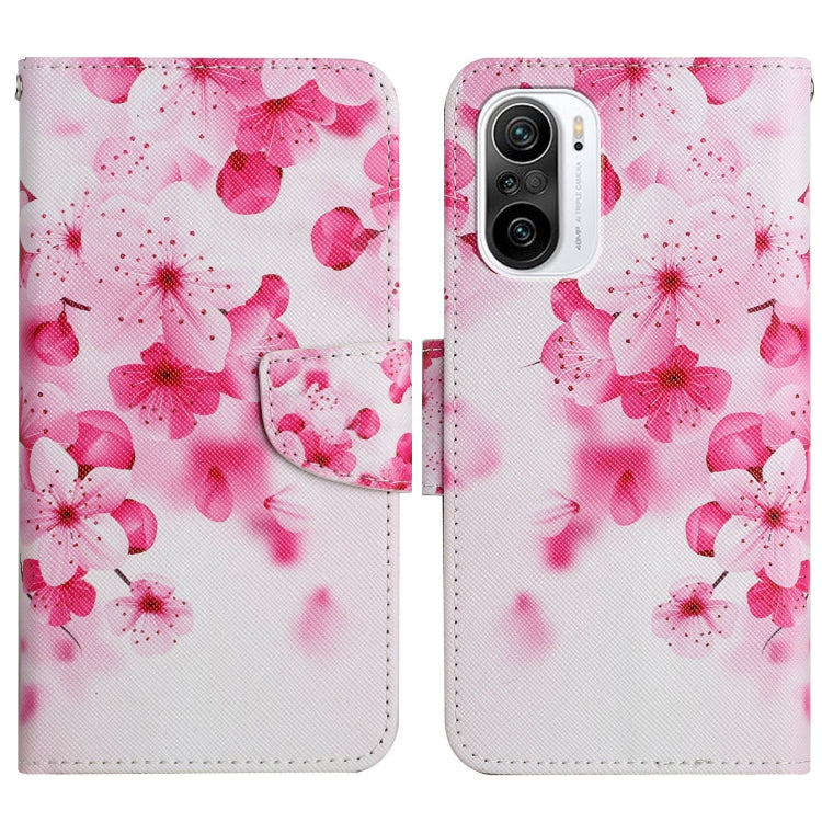Flip leather phone case with pink cherry blossom pattern, snap closure and card slot.