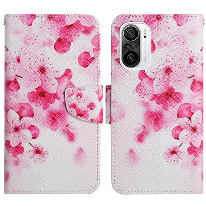 Flip leather phone case with pink cherry blossom pattern, snap closure and card slot.