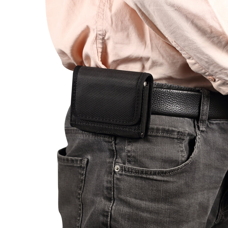 Black textured folding phone case clipped to jeans belt with front flap