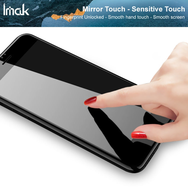 Tempered glass screen protector film being applied by hand on phone