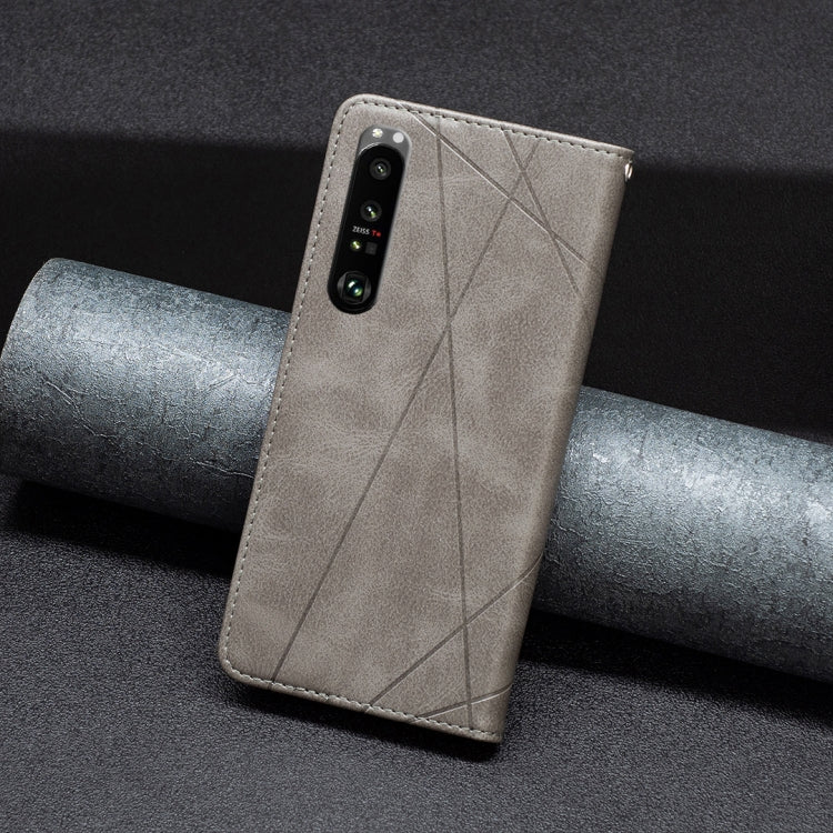 Light gray leather phone case with geometric diagonal stitching and camera cutout, magnetic flap.