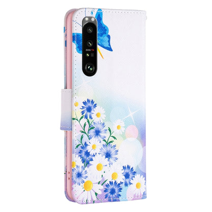 Leather phone case back with blue butterfly and blue flower pattern; cutout for dual cameras