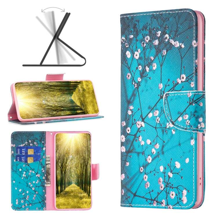 Leather phone case with blue cherry blossom branch print and pink blossoms; folio strap