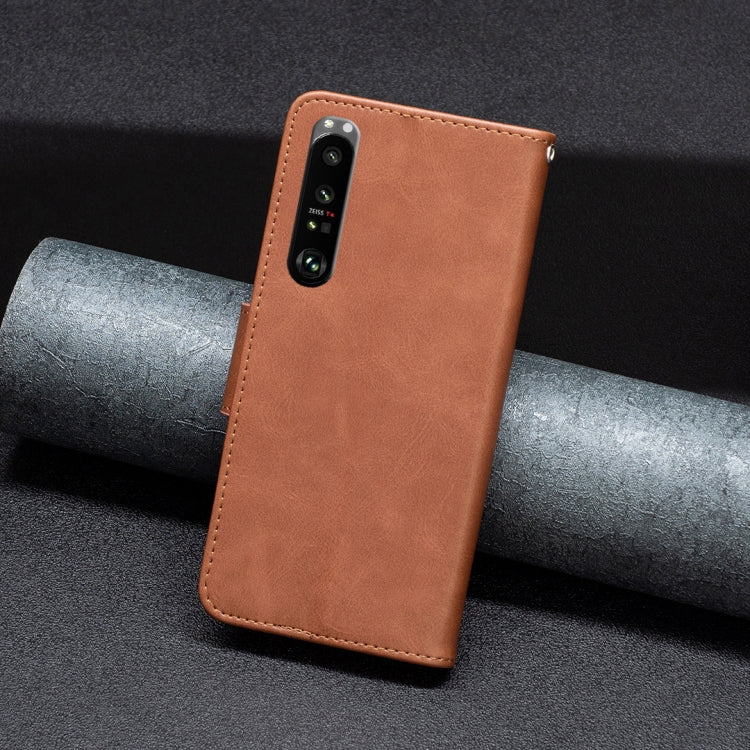 Brown leather phone wallet case with camera cutout and stitched side edges