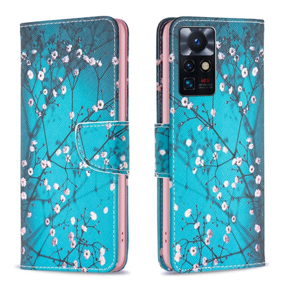 Leather phone case with blue blossom tree pattern, flip cover and camera opening.