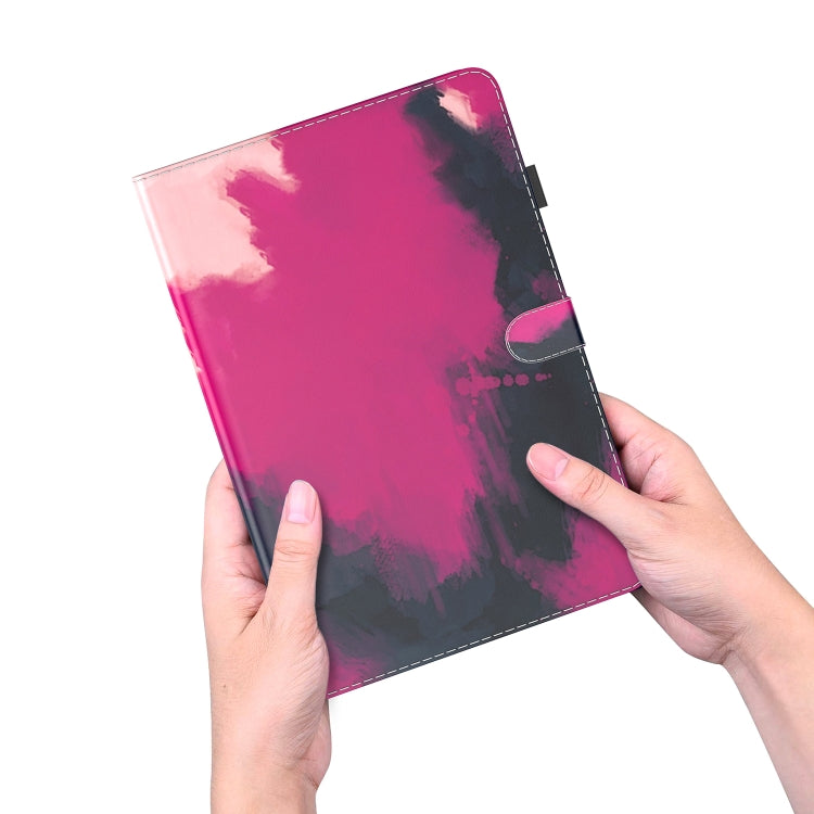 Hands holding a berry pink watercolor magnetic tablet case with side magnetic flap