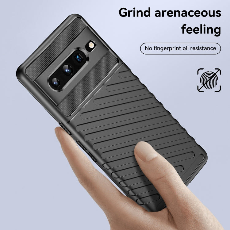 Black shockproof TPU phone case on a hand, showing back ridges and camera lens openings
